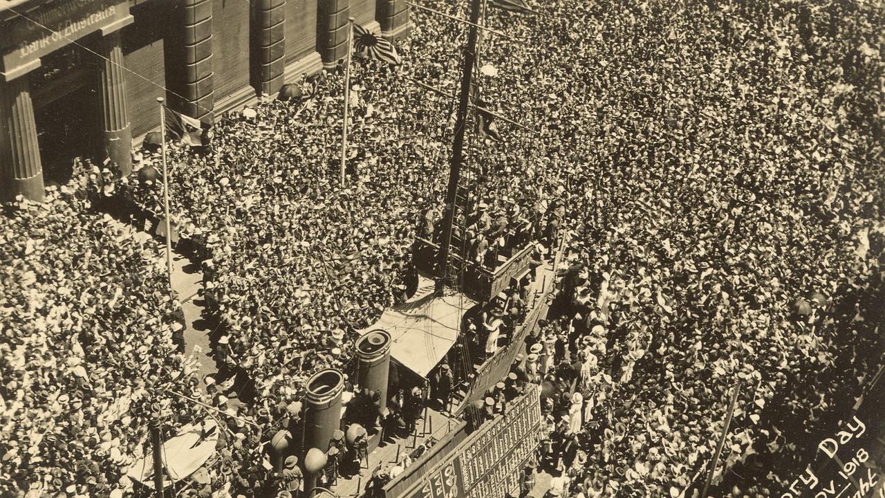 Sirens wailed, bells rang and thousands of Sydneysiders turned out for the peace celebrations in Martin Place following the announcement that World war I was over. Picture: State Library of NSW.