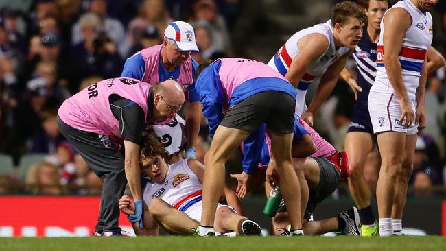 Picken being helped by Bulldogs medical staff after being knocked out against Fremantle. Picture: Getty