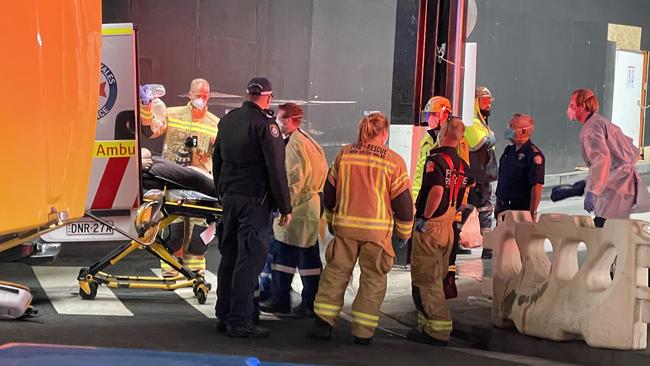 Paramedics work on a truck driver found slumped over his wheel on Church St, Parramatta.