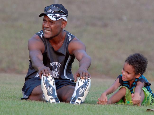 NTFL Palmerston training Jerry Frank stretches up with son (grey to id)