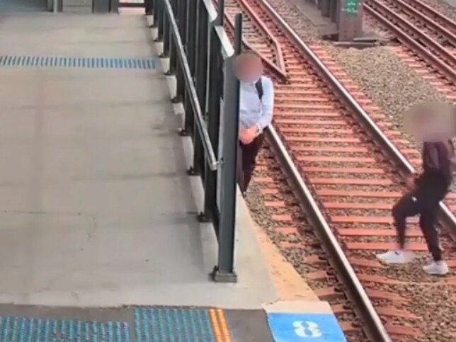 Two young people walking across the tracks at Burwood station. Picture: Supplied