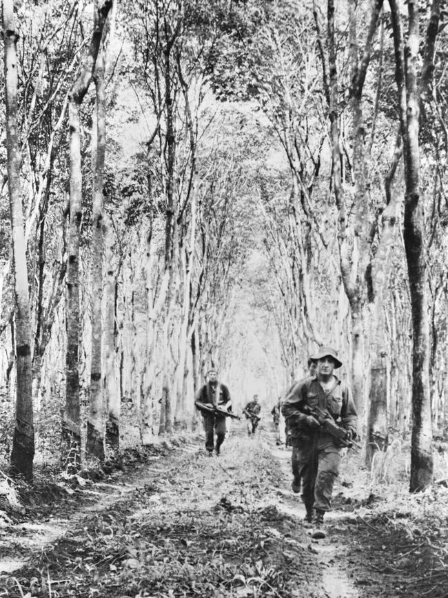 A patrol from 10 Platoon, D Company, 4th Battalion, The Royal Australian Regiment – New Zealand (ANZAC) (4RAR/NZ), follow a track through a rubber plantation during Operation Ivanhoe. Picture: Australian War Memorial/P07256.013