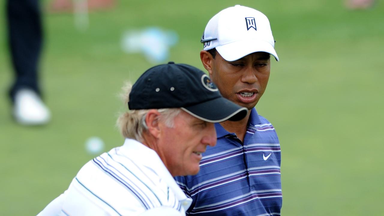 Former world number one Tiger Woods (right) chats with Australian golfer Greg Norman on the putting practice green ahead of the Australian Open Golf Championship at The Lakes Golf Club, Sydney, Tuesday, Nov. 8, 2011. The Australian Open gets underway this Thursday and includes Dustin Johnson, Adam Scott and Bubba Watson making up a huge field of the worlds top golfers. (AAP Image/Dean Lewins) NO ARCHIVING