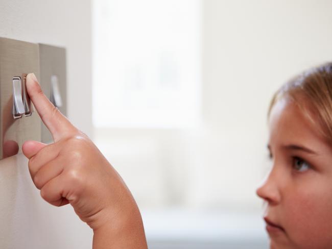 Young Girl just about to Turn Off Light Switch Picture: Istock