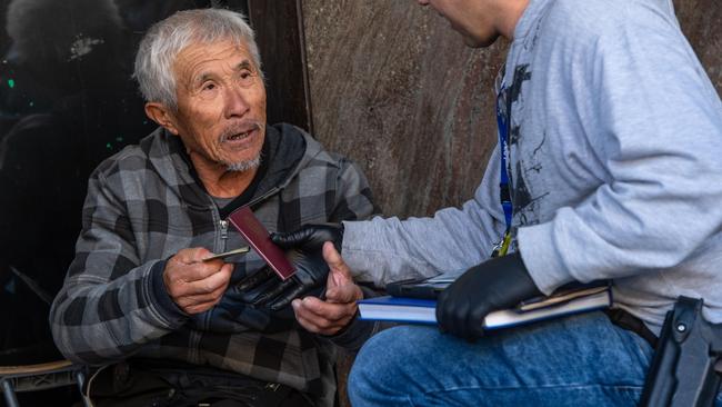 Police speak to a man in Melbourne’s CBD. Picture: Jason Edwards