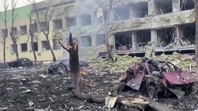 A badly damaged children's hospital, with destroyed cars and debris, following a Russian air strike in the southeastern city of Mariupol. Picture: AFP/National Police of Ukraine