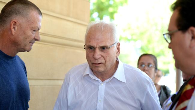 Plaintiff Colin Preston, left, confronts Robert Wayne Collins, centre, outside the District Court.