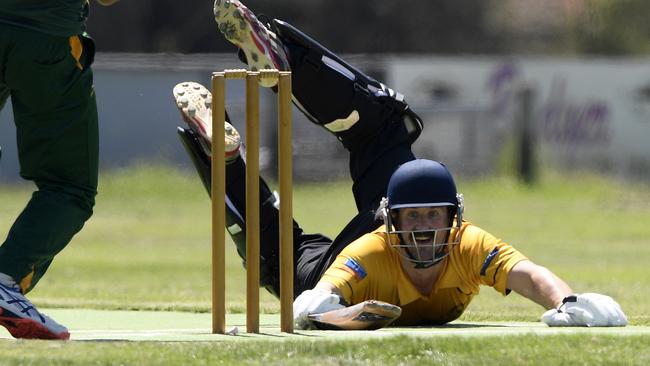 Ryan Billinghurst dives to make his ground for Sunbury United. Picture: Andy Brownbill