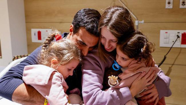 Yoni Asher being reunited with his children Aviv, 2.5 years old, her sister Raz, 4.5 years old, and his wife Doron, a day after they were released by Hamas. Picture: AFP