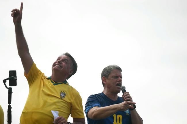 Brazil's former president Jair Bolsonaro (L) gestures next to Sao Paulo Governor Tarcisio de Freitas during a rally in Rio de Janeiro on March 16, 2025