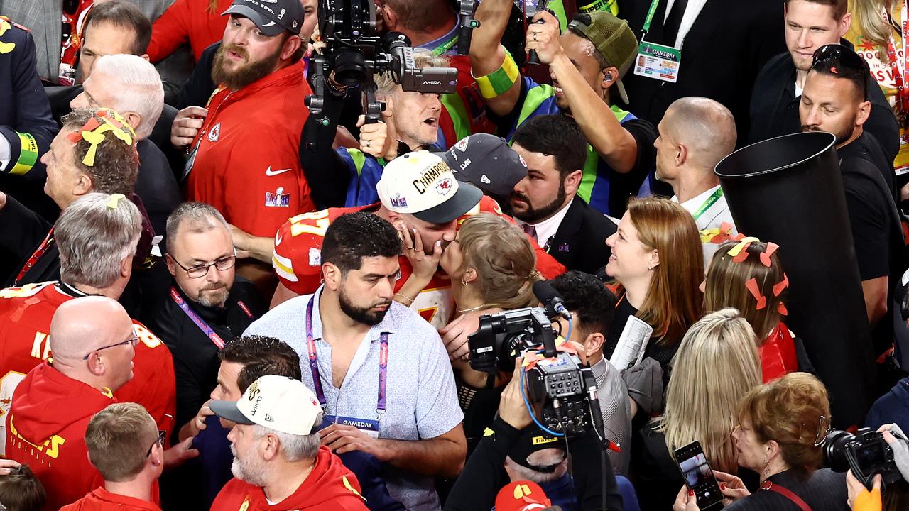 Travis Kelce #87 of the Kansas City Chiefs kisses Taylor Swift after defeating the San Francisco 49ers.