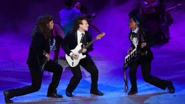 Christian Charisiou, centre, rocks out with bandmates Haydan Hawkins, left, and Ed Deganos, right, in The Wedding Singer musical. Picture: Tom Huntley