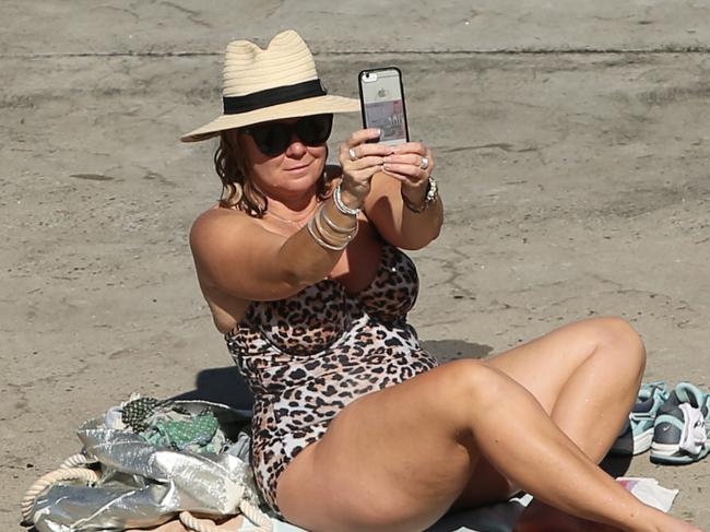 A sunbaker pictured  at Clovelly Beach in Sydney. Directives state that the beach is open for exercise only and not hanging out.The public has been asked to adhere to the strict social distancing guidelines put in place by the government to combat the spread of Covid-19.Picture: Richard Dobson