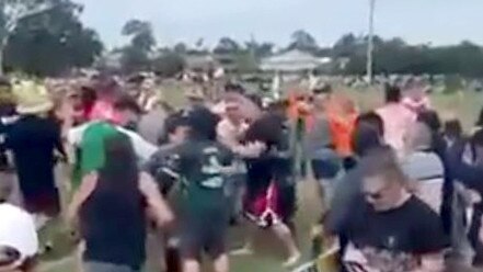 Two men have been charged over this wild brawl at a junior rugby league game in Brisbane.