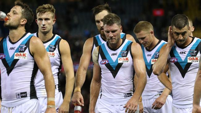 Power players leave the field after their loss to Essendon.