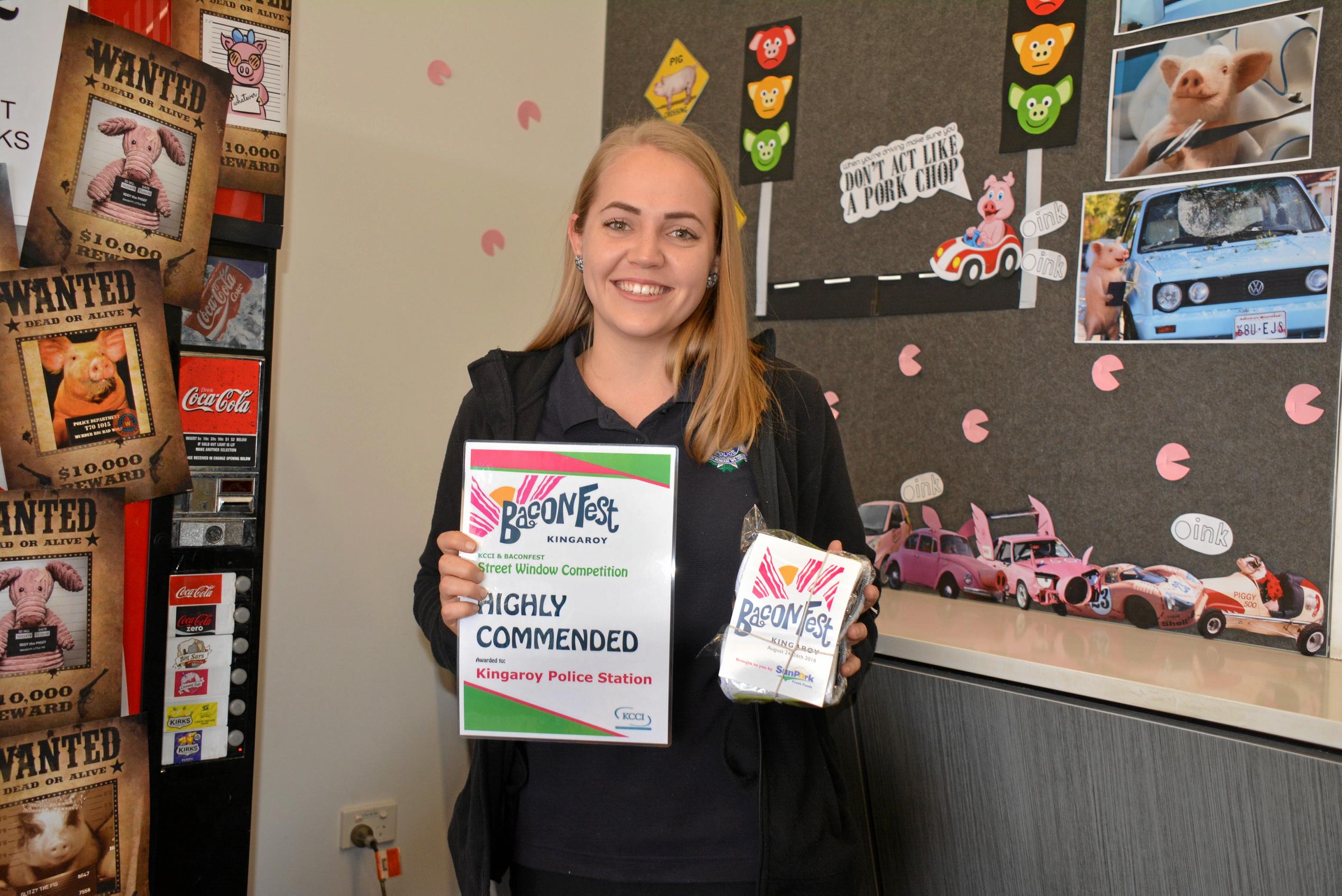 WANTED: Kingaroy police admin officer Emmy Cooper accepts the station's highly commended for the BaconFest Street Window competition. Picture: Jessica McGrath