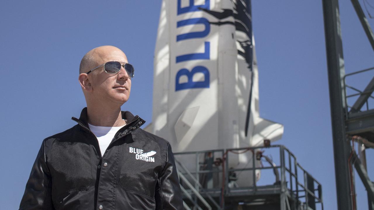 Jeff Bezos poses in front of his rocket ship. Picture: Getty Images