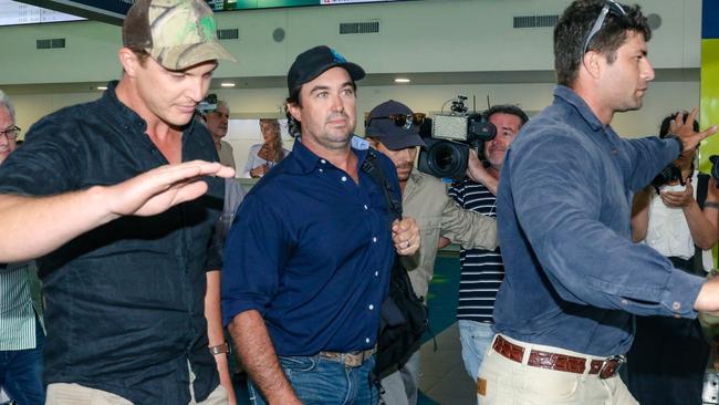 Matt Wright arrives in Darwin flanked by security to present himself to NT Police. Picture: Glenn Campbell