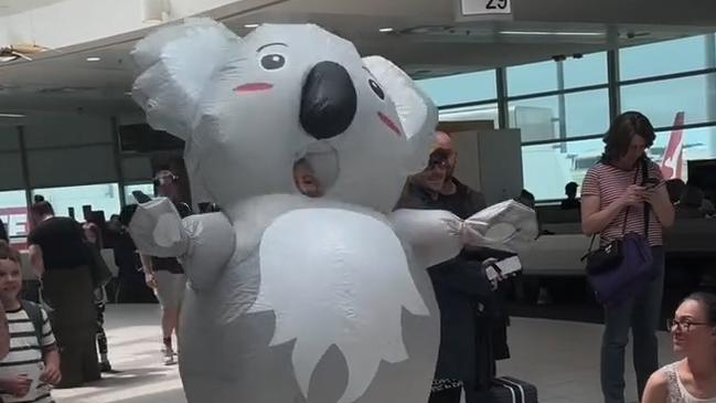 Janelle Spies, 33, from Noosa runs through the Brisbane Domestic Airport as a koala to surprise her sisters in this screenshot from a now viral video. Picture: Supplied