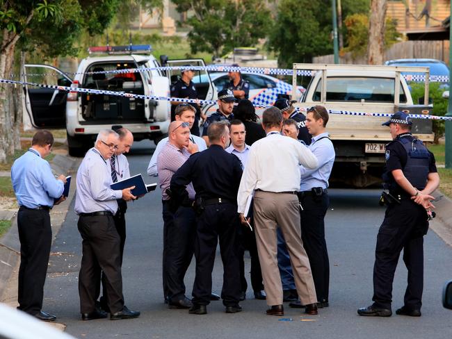 Detectives at the scene of the fatal shooting.