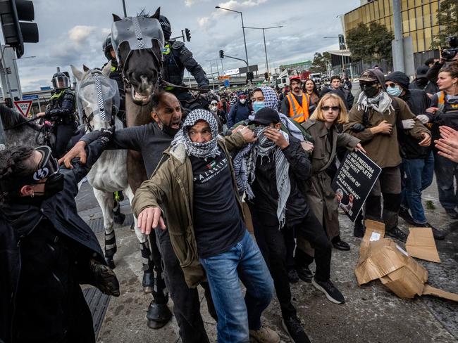 BEST PICS 2024Anti-war activists protest the Land Forces 2024 International Land Defence Exposition at the Melbourne Convention and Exhibition Centre. Police mounted unit charges protesters at South Wharf. Picture: Jake Nowakowski