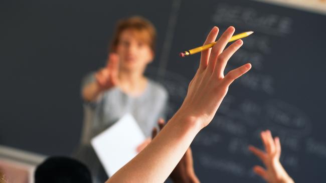 Teacher pointing to raised hands in classroom, Classroom, teaching generic, education generic, Teacher, Learning, Hand Raised, Education, Adult, School Building, Pointing, Standing, Image, Women, Adults Only, Colour Image, Horizontal, Human Arm, Human Body Part, Human Limb, Incidental People, Indoors, Limb, One Person, Only Women, People, Photography, thinkstock, generic, istock