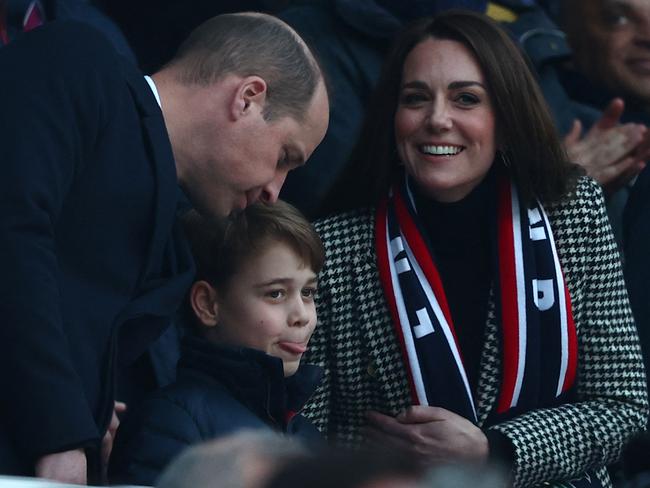 Britain's Prince William, Duke of Cambridge, (L), Britain's Prince George of Cambridge (C) and Britain's Catherine, Duchess of Cambridge, (R) attend the Six Nations international rugby union match between England and Wales at Twickenham Stadium, west London, on February 26, 2022. (Photo by Adrian DENNIS / AFP)