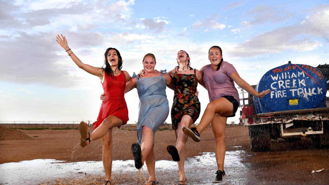 FOR FRIDAY PAPERHOT WEATHER - WILLIAM CREEK. International tourists staying at William Creek (l-r) Julia Mertz (19, Switzerland), Nicole Baldry (22, England), Amy Thompson (24, Scotland) and Brittany Lewis (21 from Wales) cool off under a hose as the weather hits mid 40's. Picture: Tricia Watkinson.