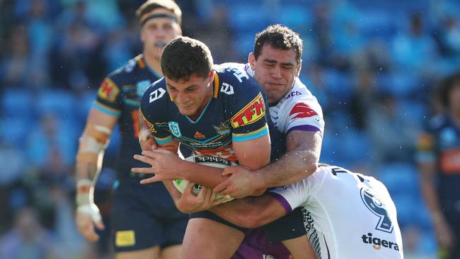 Stone is tackled by Dale Finucane and Cameron Smith. Picture: Getty Images