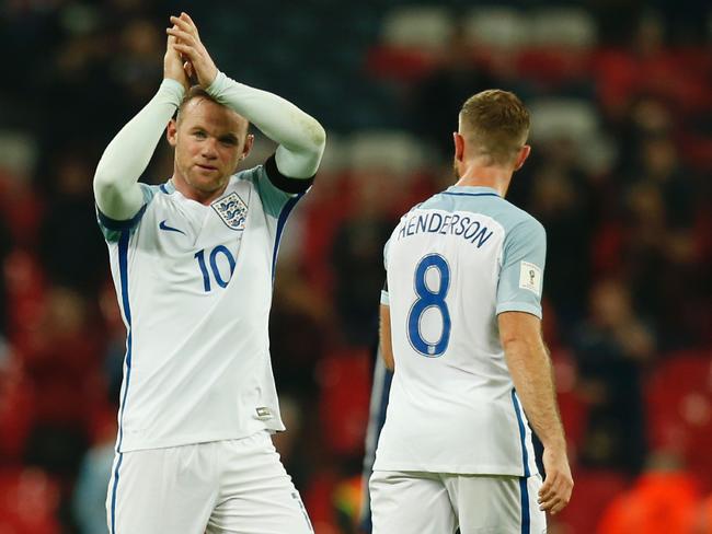 England's striker Wayne Rooney celebrates after beating Scotland.