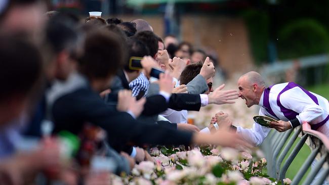 2012: Jockey Glen Boss feels the love from fans at Moonee Valley after his winning ride on Ocean Park in the Cox Plate. Picture: Alex Coppel