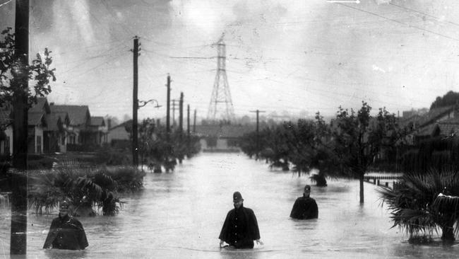 Constables from Hawthorn rescue families in Kaikoura Avenue who were trapped by the flooded Gardiner’s Creek on November 30 1934.