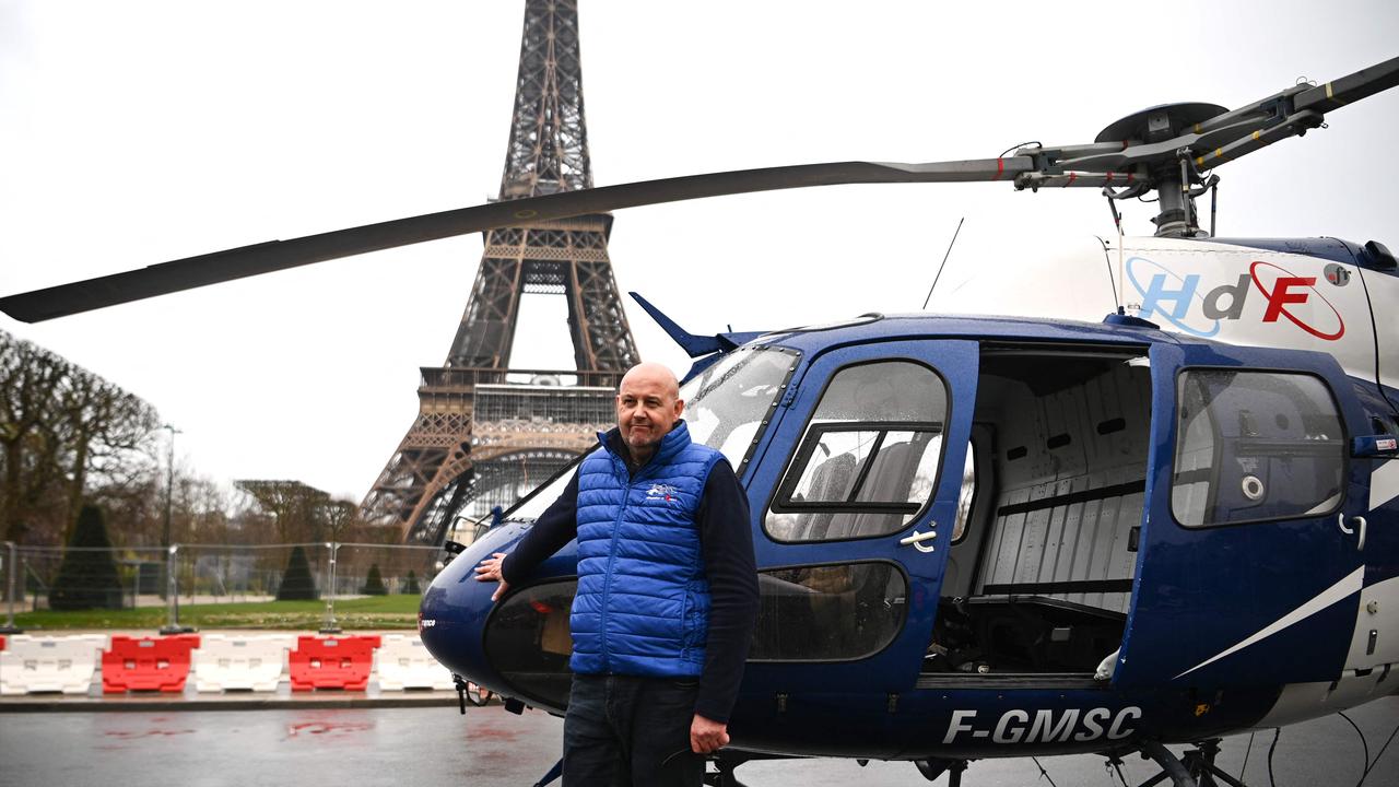 Helicopter pilot Franck Charlet in front of the Eiffel Tower in Paris after he installed the new 6m antenna at the top of the Eiffel Tower on March 15. Picture: Christophe Archambault/AFP
