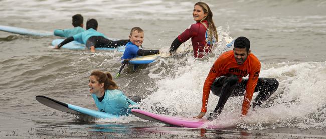 Derek Rabelo and Rachael Leahcar — at Glenelg Beach for Royal Society for the Blind surfing event Saturday June 15, 2019. Picture: AAP/Mike Burton