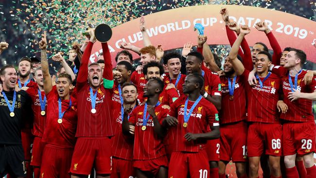 Liverpool captain Jordan Henderson lifts the Club World Cup trophy.