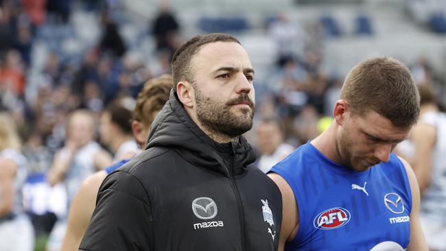 GEELONG, AUSTRALIA - JULY 09: Griffin Logue and Aidan Corr of the Kangaroos walk from the ground after during the round 17 AFL match between Geelong Cats and North Melbourne Kangaroos at GMHBA Stadium, on July 09, 2023, in Geelong, Australia. (Photo by Darrian Traynor/Getty Images)