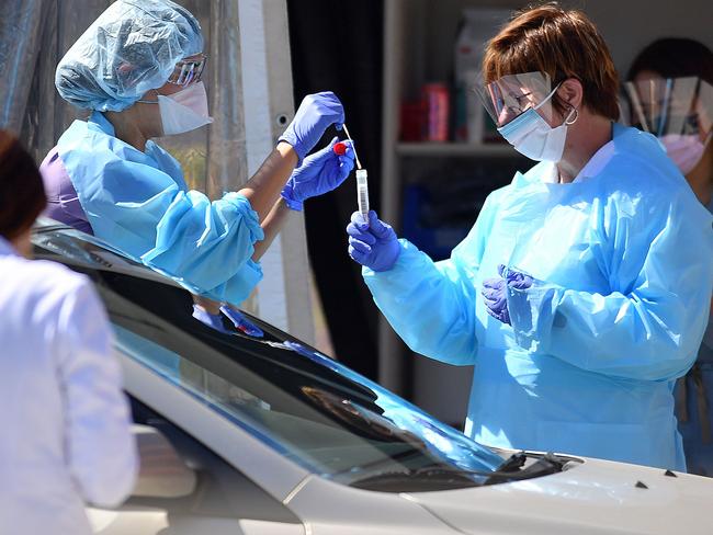 Medical workers test a patient for COVID-19 at a drive-through testing facility in San Francisco, California. Picture: AFP