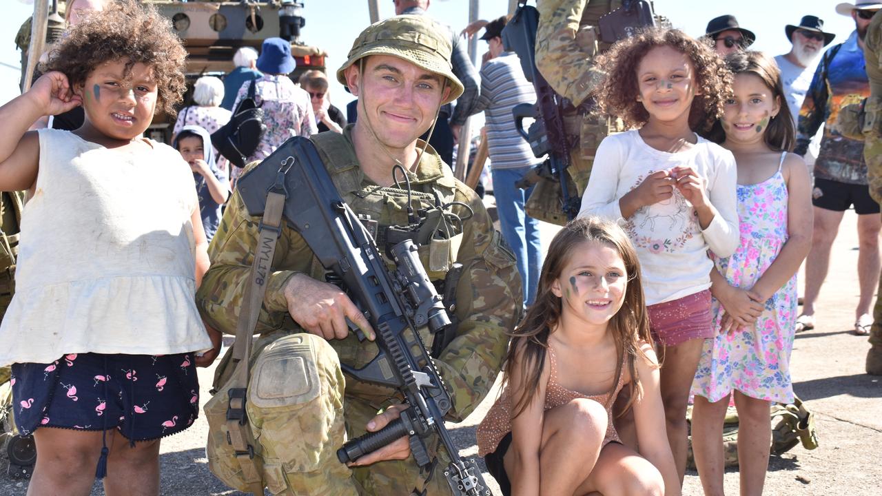 Shakita-Rose Daniel-Fenn, Porscha Fenn, Ramiyah Sullivan, and Halliana Fenn of Bowen with PTE Braydon Mylne of Townsville's riflemen at the Exercise Talisman Sabre open day. Picture: Kirra Grimes