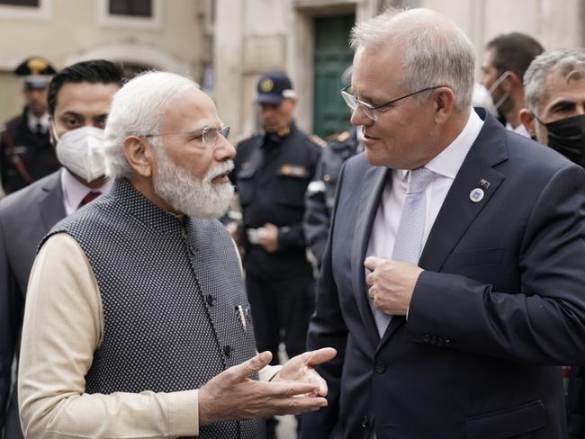 Australian Prime Minister Scott Morrison and Indian President Nerandra Modi talk before the G20 leaders make a short visit to the Fontana di Trevi to throw a coin in the fountain to make a wish before the start of the second day of the G20 in Rome on Sunday, October 31, 2021. Picture: Adam Taylor