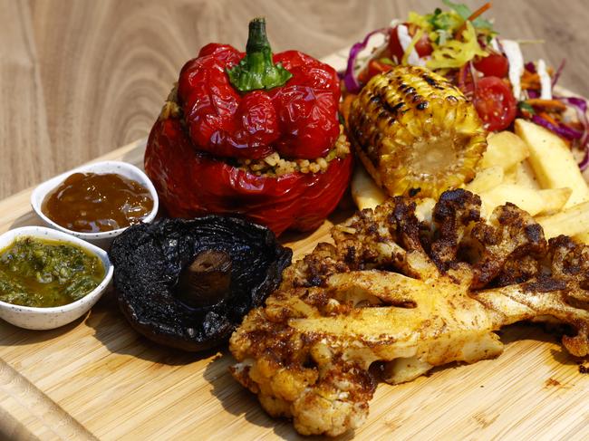 Blackened cauliflower steak, grilled corn cob, slaw and green tomato relish at the Roast Republic in the Sydney CBD. Picture: Jonathan Ng
