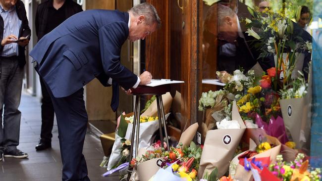 Bill Shorten signs a condolence book outside Pellegrini’s Espresso Bar. Picture: William West/AFP