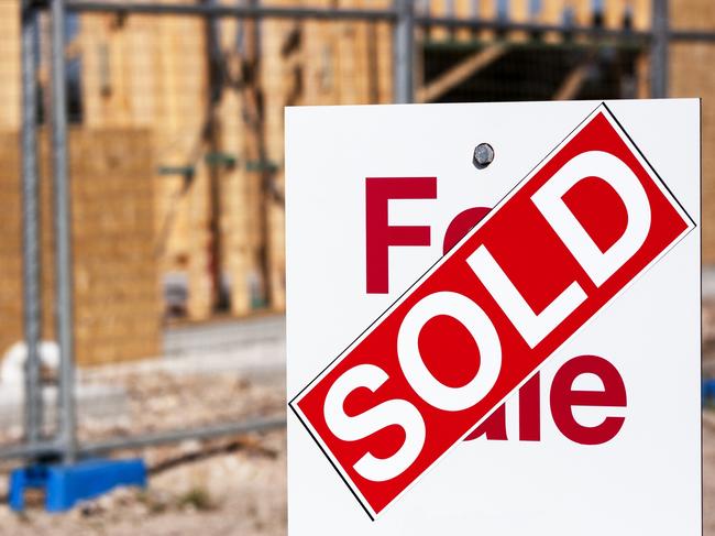 Red and white sign SOLD, land for sale in new suburb development full frame horizontal composition with copy space