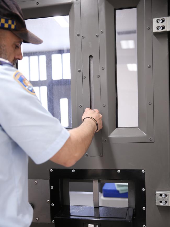 Each cell has a portal where inmates are handcuffed and locked to the front door so officers can enter via the rear. Picture: Sam Ruttyn