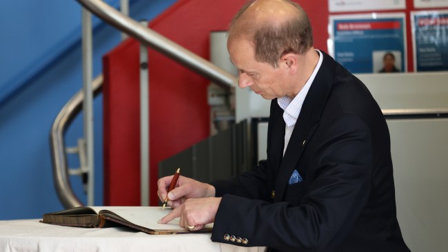 Prince Edward signed the visitor book at the PCYC in Woolloomooloo. Picture: Brendon Thorne/Getty Images