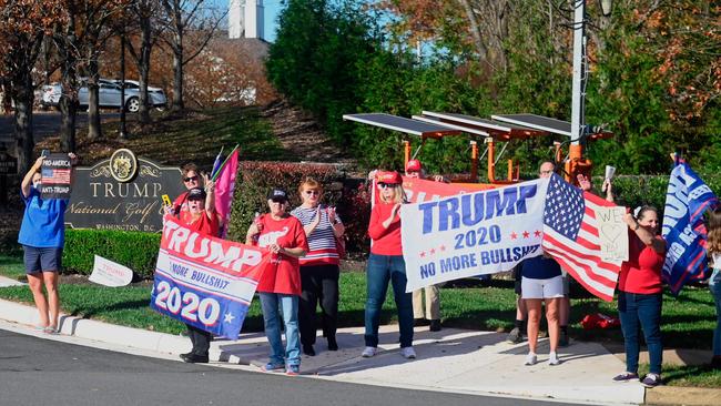 Supporters of US President Donald Trump wait for his motorcade, to drive by as he returns to the White House in Washington DC on November 7. Picture: AFP