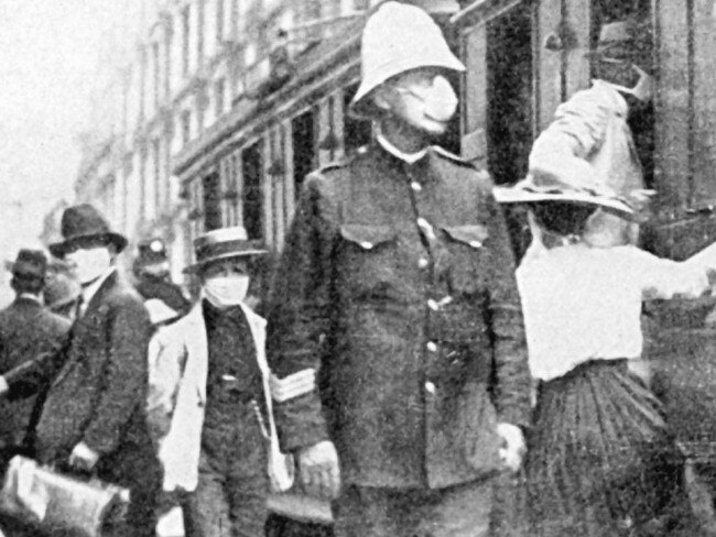 Masks and trams on the streets of Sydney: a scene common in both 1919 and 2020.