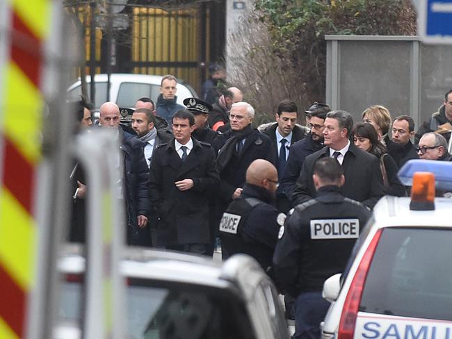 French Prime Minister Manuel Valls (centre) arrives at the offices of the French satirical newspaper Charlie Hebdo. Picture: Getty Images