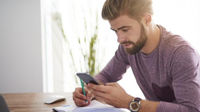 Planning work in the calendar; man with diary, checklist, phone and pen. bills money generic