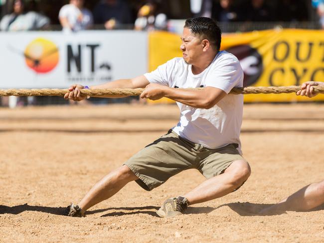 A competitor digs his feet into the sandy bed of the Todd River for the 