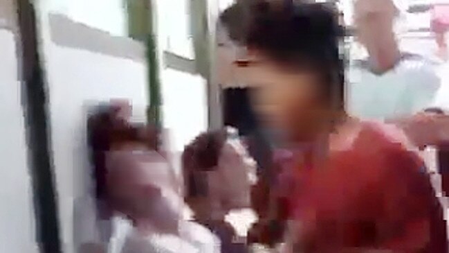 A screen grab from the sickening video of a teenage student being punched in the face at Darwin High School